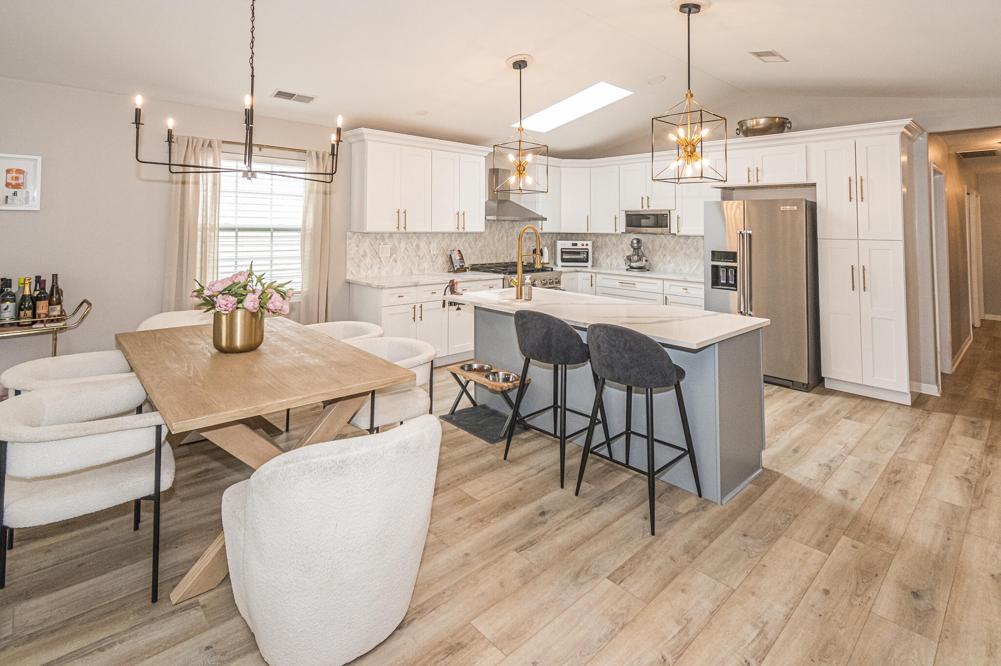 10735 Keystone Lane Crown Point, IN 46307 - Photo 9 of 23 a kitchen with stainless steel appliances kitchen island granite countertop a table chairs and a wooden floor