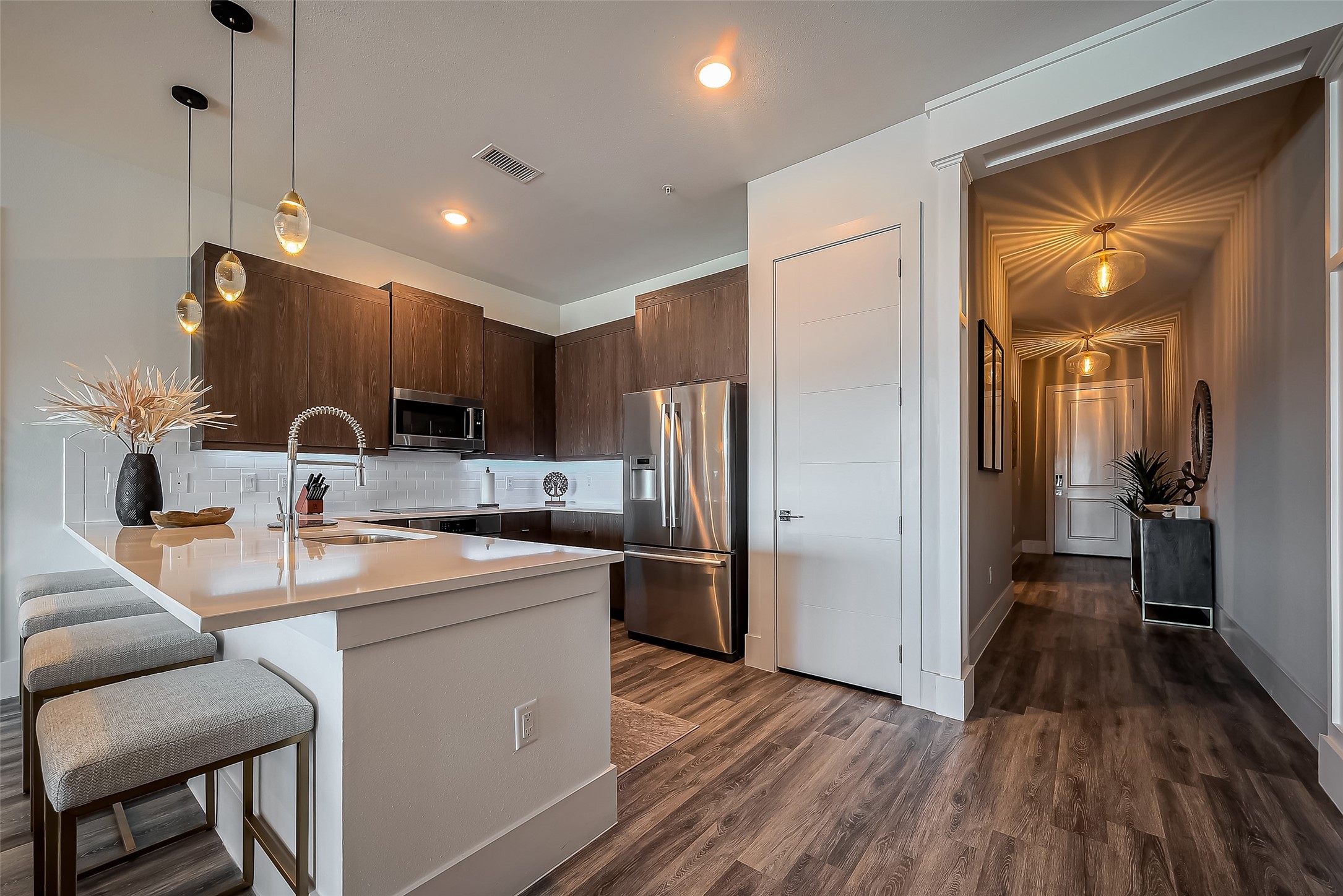 199 Waterpoint Court, Unit 302 Conroe, TX 77356 - Photo 3 of 20 High end kitchen with sleek countertops, state of the art Bosch appliances, custom cabinetry, and a large island complemented by a picturesque lake view from the living room windows.