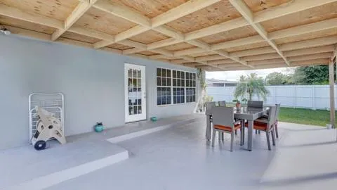 a dining room with furniture and a garden view