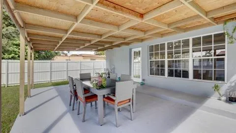 a view of a porch with furniture and a yard
