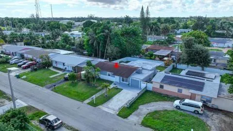 an aerial view of a house with garden space and street view