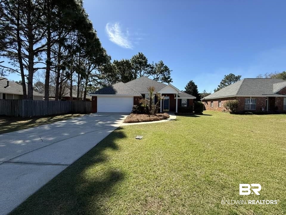 10428 South Side Loop Fairhope, AL 36532 - Photo 2 of 28 Single story home featuring an attached garage, driveway, a front lawn, and fence