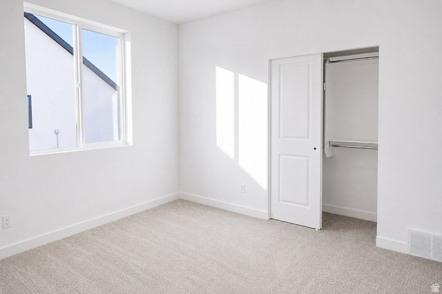 1004 West Paramount Cove South, Unit 315 Ogden, UT 84405 - Photo 22 of 42 Main floor bedroom featuring a sliding closet with white doors and built-in shelving