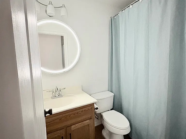 430 Summit Ridge Drive North Point Venture, TX 78645 - Photo 14 of 26 A well-lit bathroom with a bright vanity and shower.