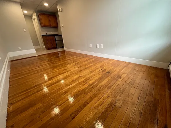 a view of an empty room with a fireplace