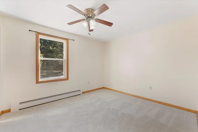 an empty room with closet and a chandelier fan