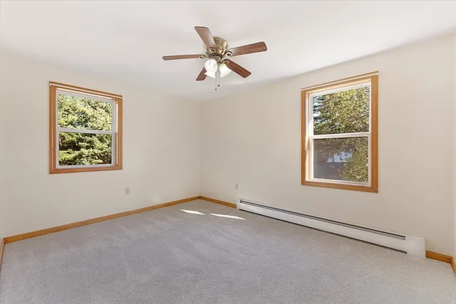 an empty room with a chandelier fan