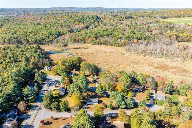 an aerial view of residential house with yard and swimming pool