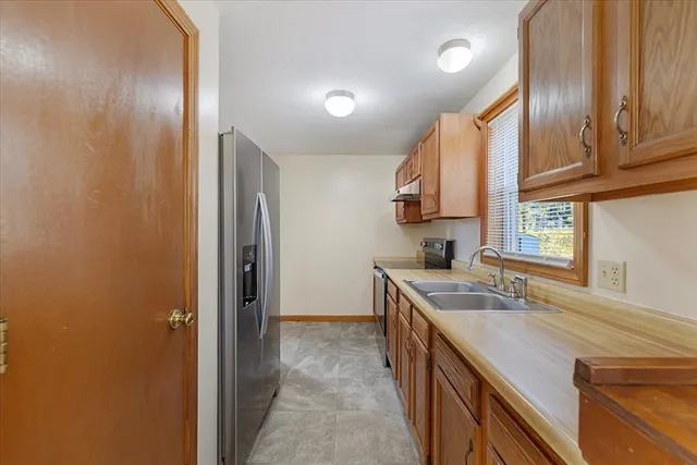 a kitchen with a sink stove and cabinets