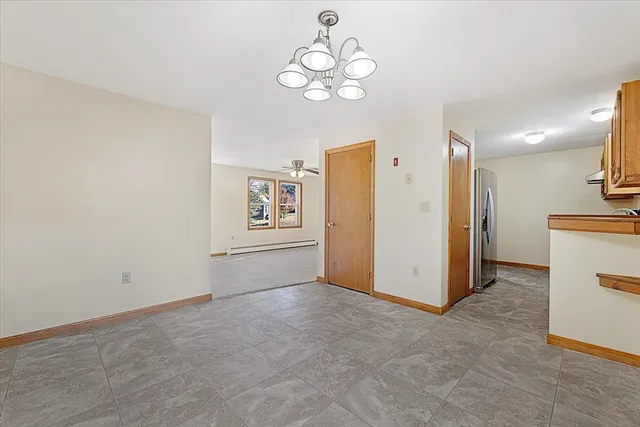 an empty room with fan and windows