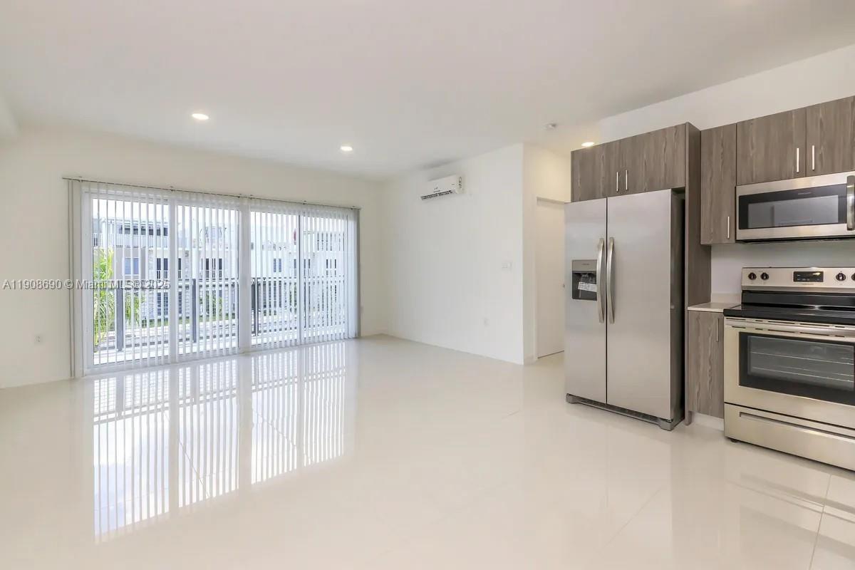 25850 Southwest 140th Court, Unit 4608 Homestead, FL 33032 - Photo 1 of 20 a view of a kitchen with refrigerator and a sink
