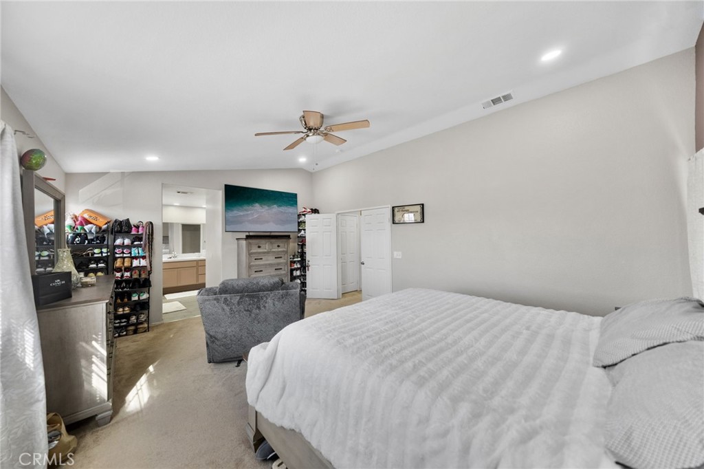 1494 Rabbit Peak Way Hemet, CA 92545 - Photo 24 of 45 a spacious bedroom with a bed and a flat screen tv