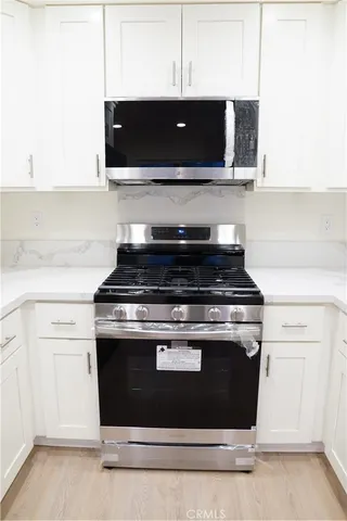 a stove top oven sitting inside of a kitchen