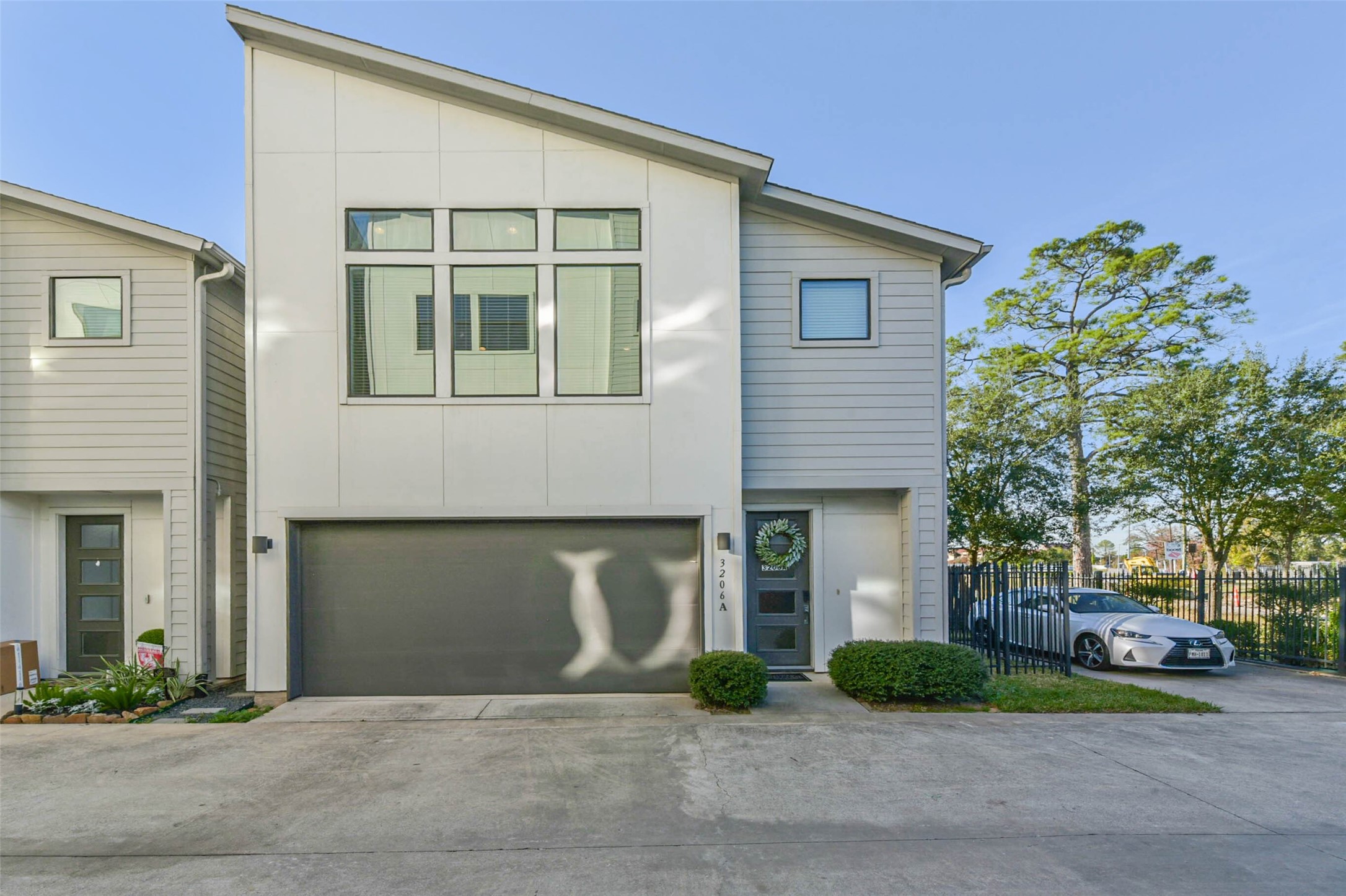 a front view of a house with a garden and garage