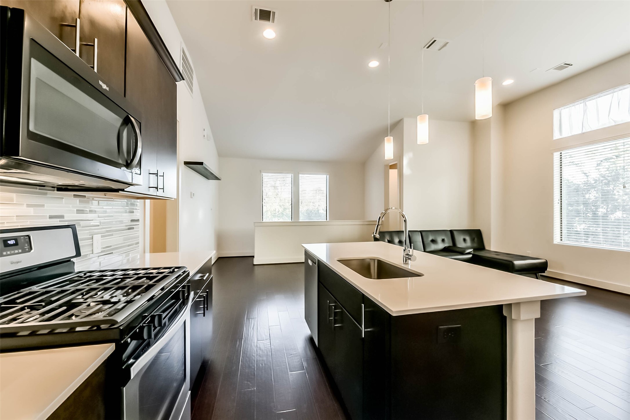 3206 North MacGregor Way, Unit A Houston, TX 77004 - Photo 18 of 30 a kitchen that has a sink a stove and chairs in it