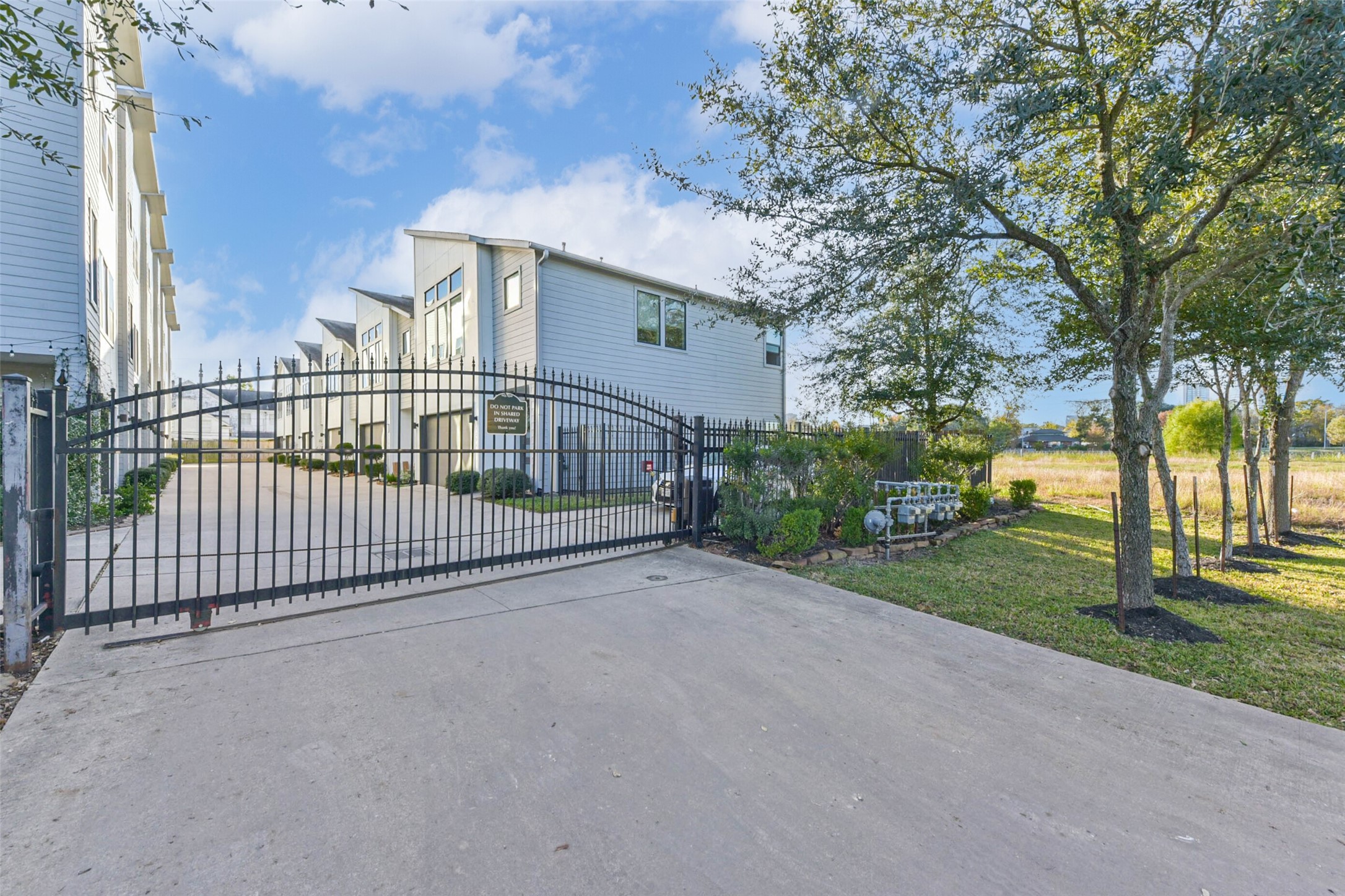 3206 North MacGregor Way, Unit A Houston, TX 77004 - Photo 30 of 30 a view of a white house in front of a big yard
