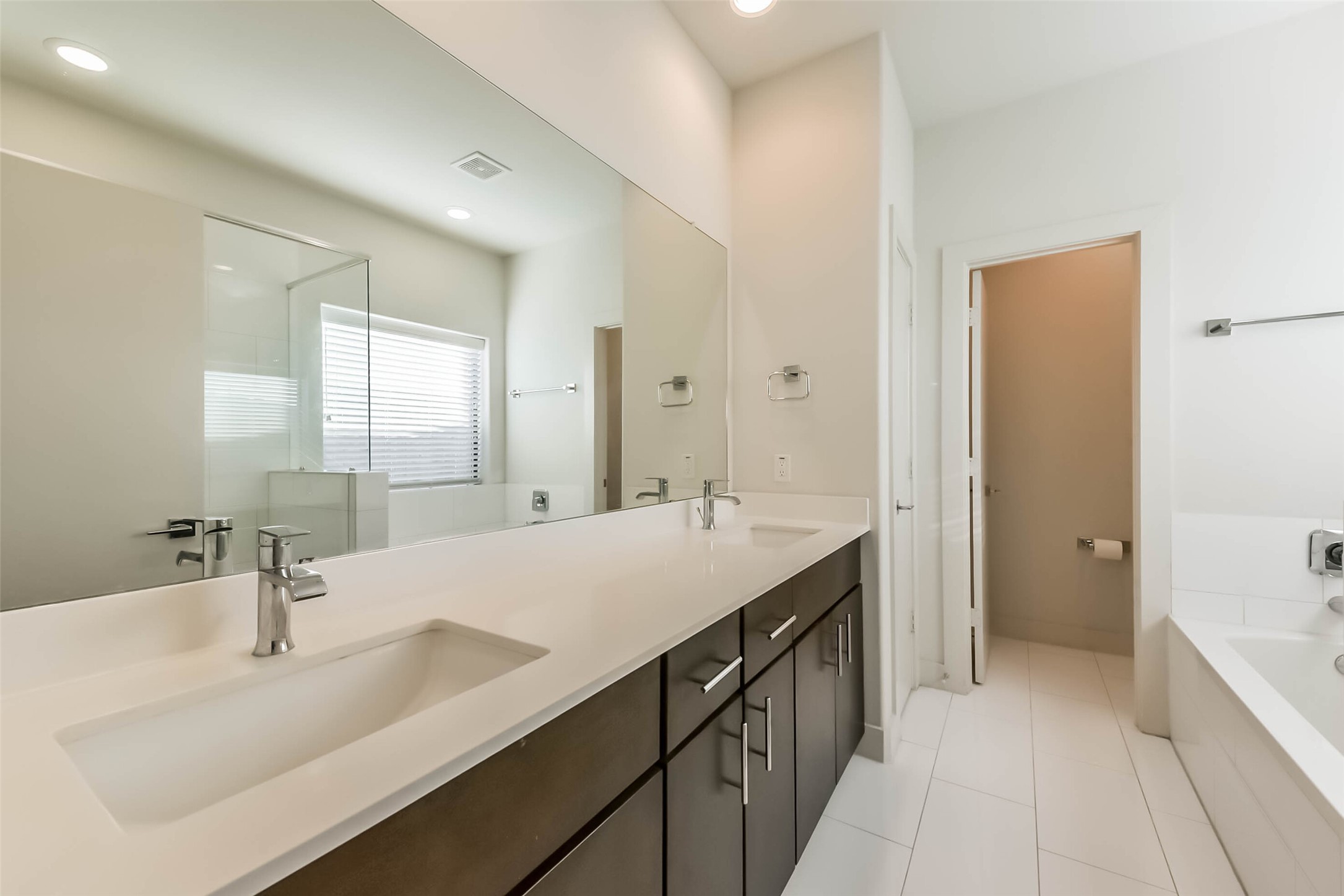 3206 North MacGregor Way, Unit A Houston, TX 77004 - Photo 10 of 30 a bathroom with a double vanity sink mirror double and bathtub