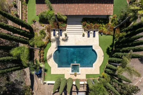 an aerial view of a house with garden space and street view