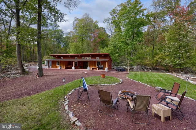 a view of a house with backyard sitting area and garden