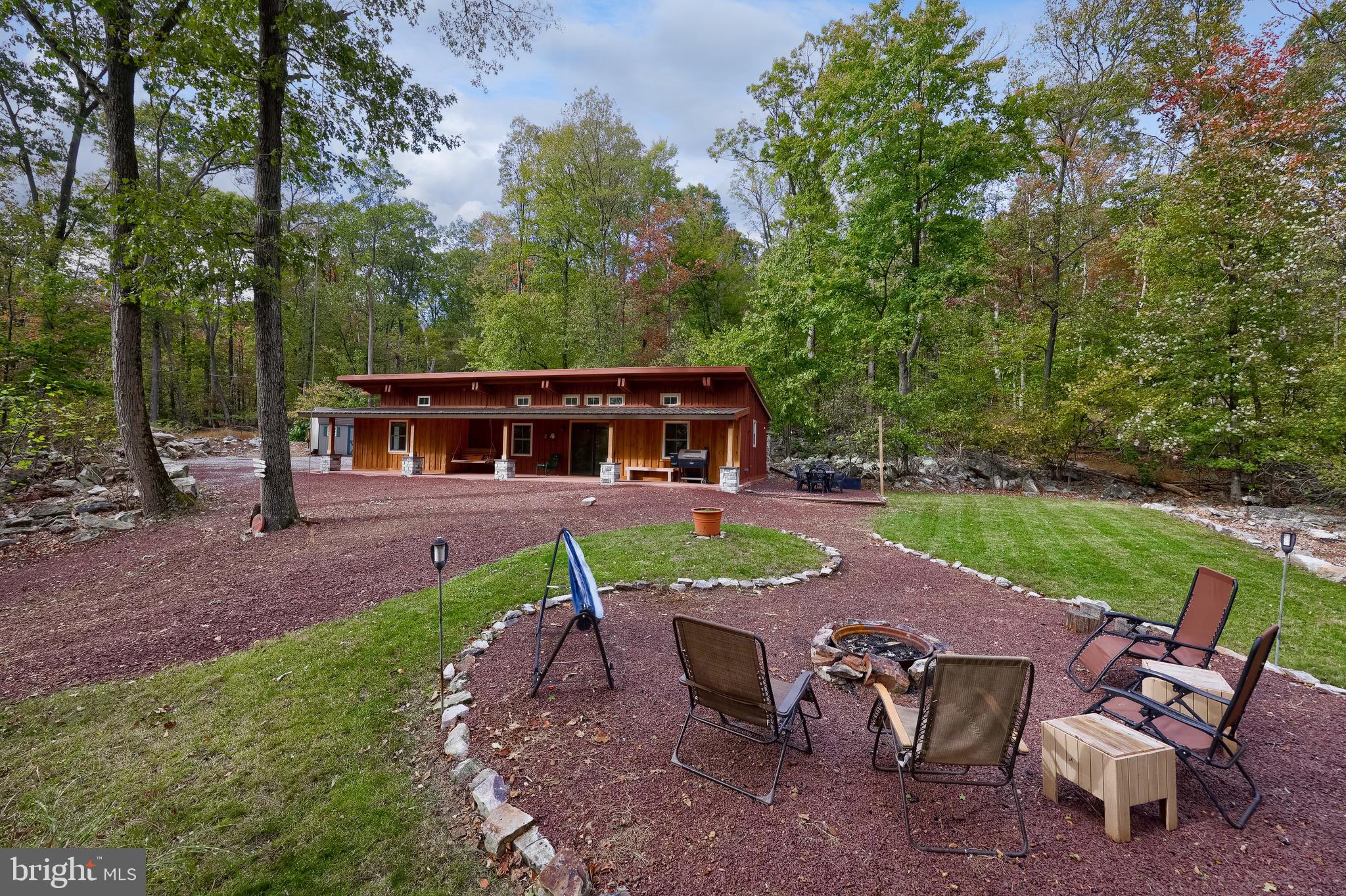 a view of a house with backyard sitting area and garden