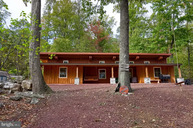 a dining hall with stainless steel appliances granite countertop a stove a sink dishwasher and a dining table with chairs