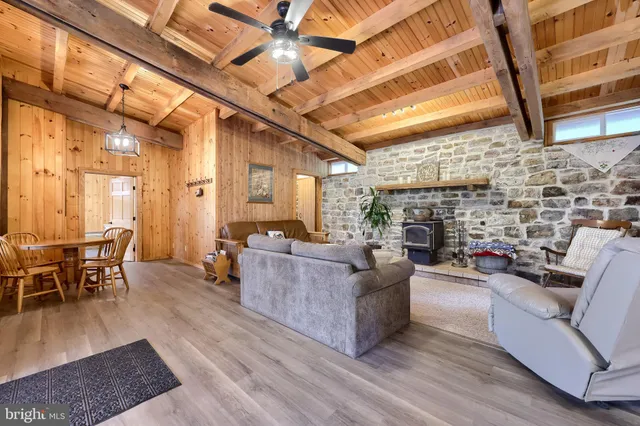 a spacious bedroom with a bed and wooden floor