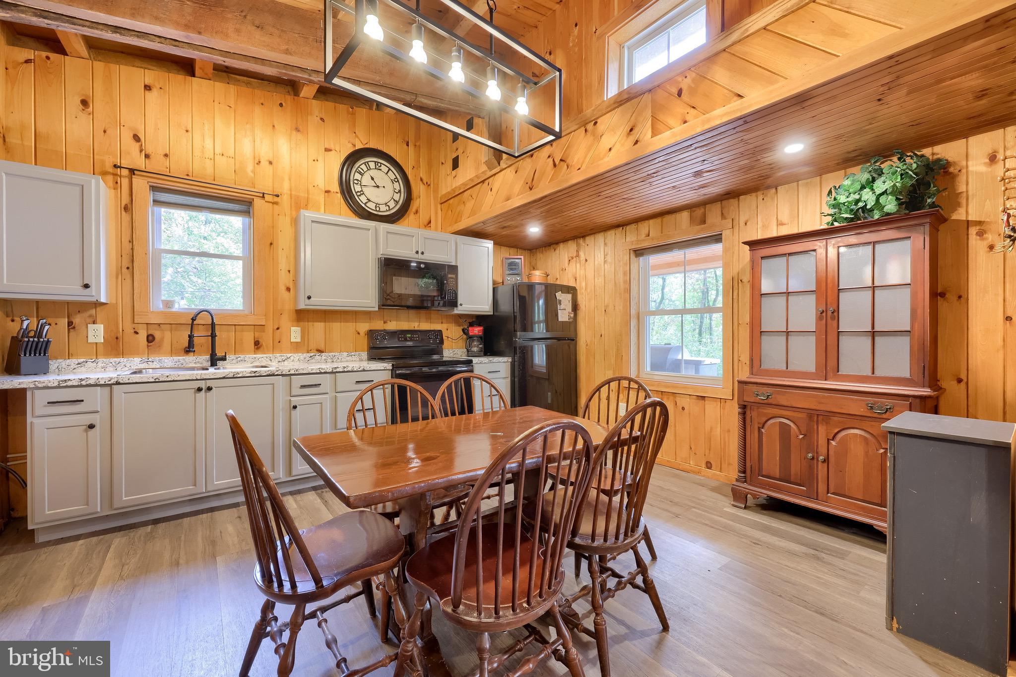 485 Airport Road Bethel, PA 19507 - Photo 22 of 71 a dining hall with stainless steel appliances granite countertop a stove a sink dishwasher and a dining table with chairs