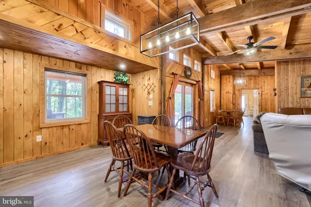 a dining room with furniture and a chandelier