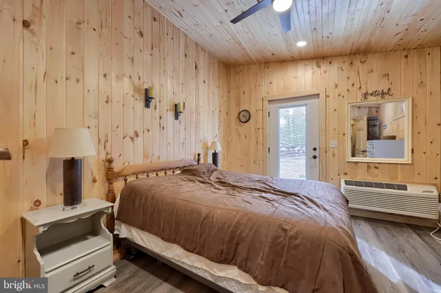 a view of a house with a yard and large tree