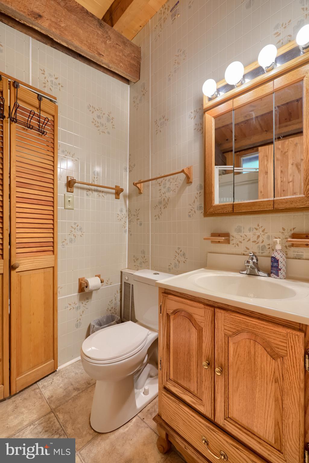 485 Airport Road Bethel, PA 19507 - Photo 34 of 71 a bathroom with a granite countertop toilet sink and mirror