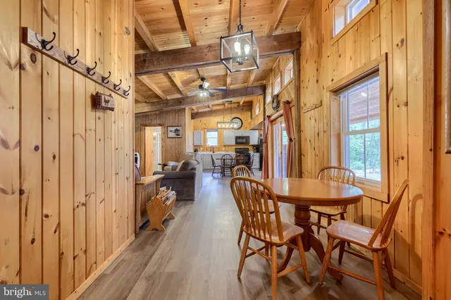 a view of a house with pool and a yard