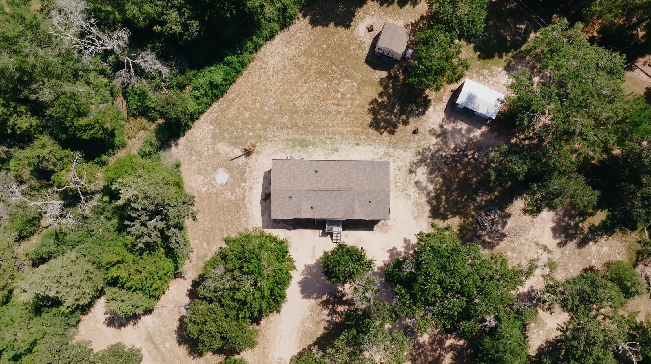 1047 Jimbob Lane New Ulm, TX 78950 - Photo 16 of 18 Aerial view of the home, storage, well house & clearing.