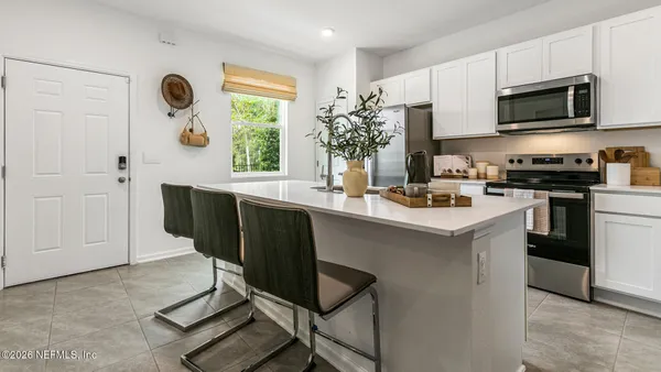 a kitchen with a sink cabinets and window