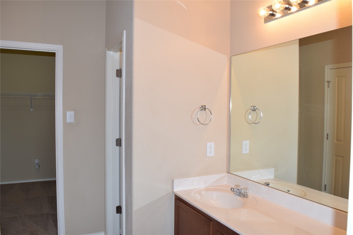 11717 Alexs Lane Austin, TX 78748 - Photo 11 of 32 a bathroom with a sink and a mirror