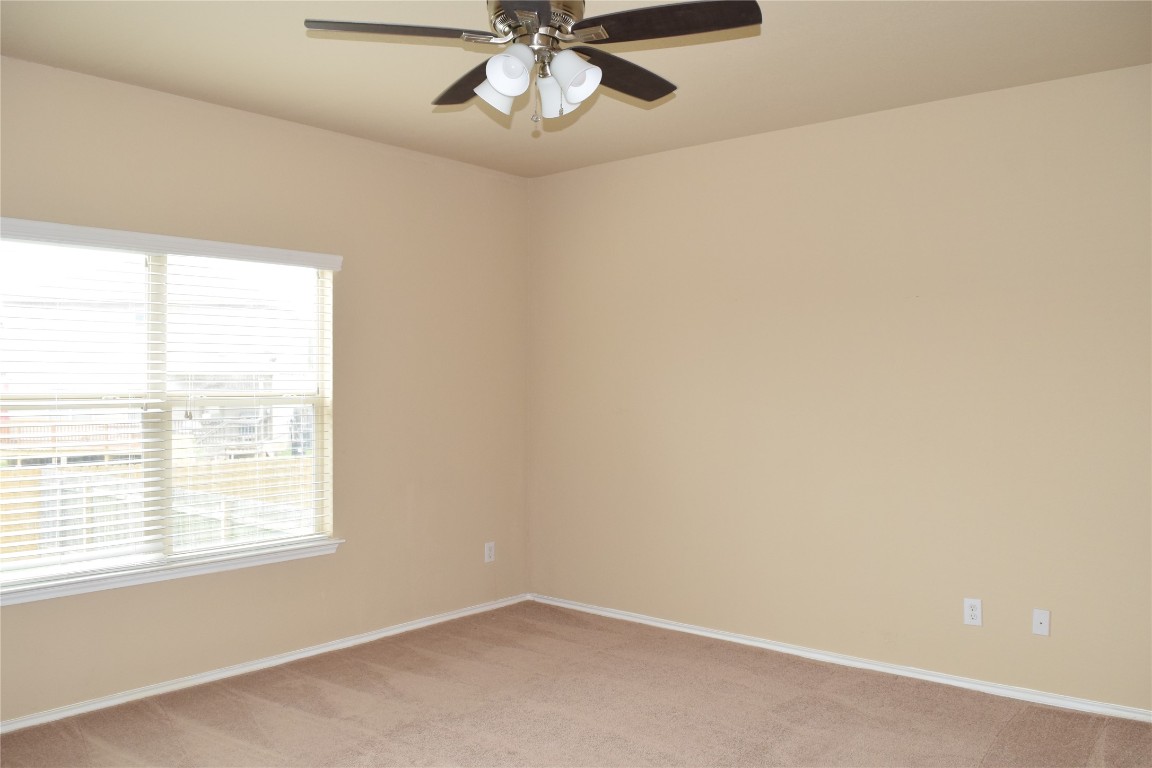 11717 Alexs Lane Austin, TX 78748 - Photo 16 of 32 an empty room with a window and a fan