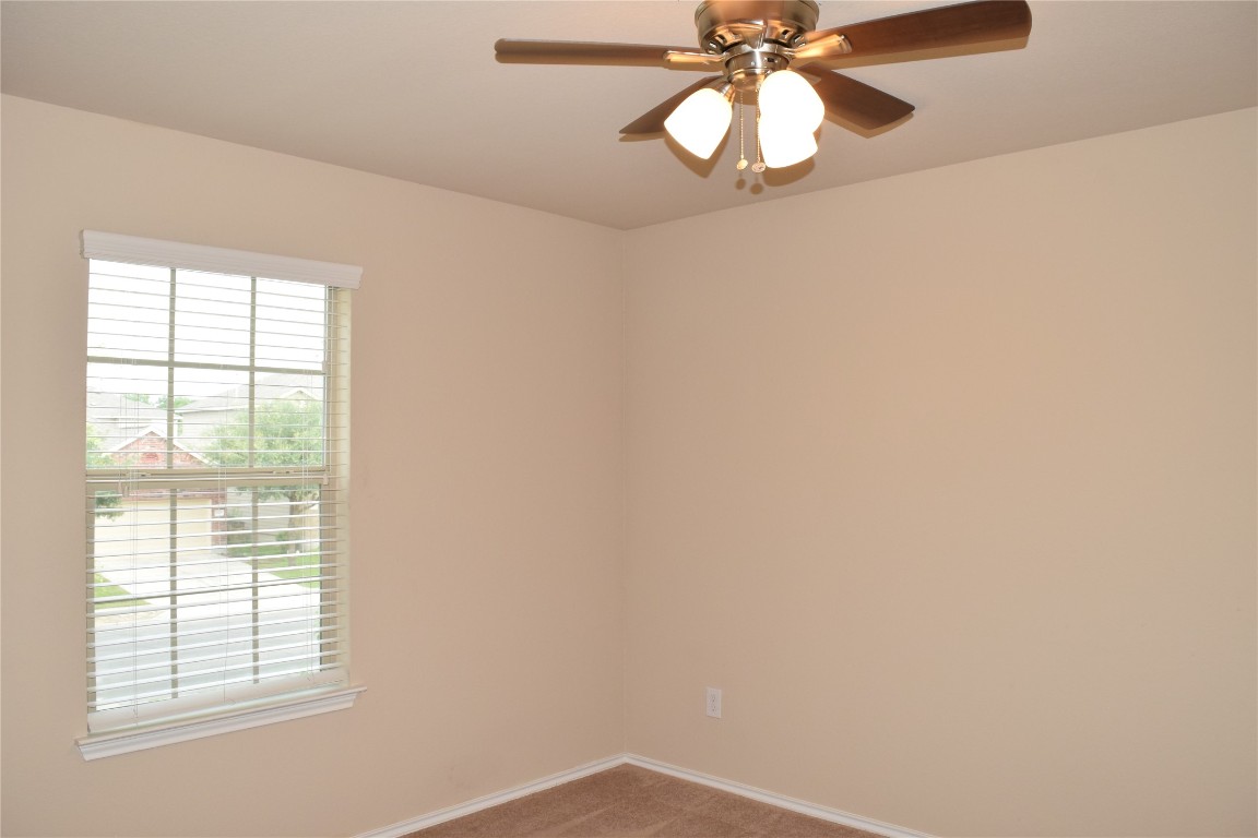 11717 Alexs Lane Austin, TX 78748 - Photo 23 of 32 an empty room with a window and chandelier fan