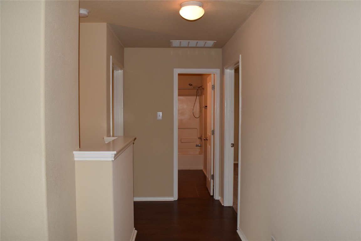11717 Alexs Lane Austin, TX 78748 - Photo 24 of 32 a view of a hallway with wooden floor