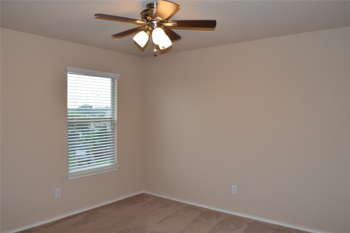 11717 Alexs Lane Austin, TX 78748 - Photo 30 of 32 an empty room with a window and a fan