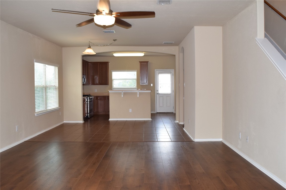 11717 Alexs Lane Austin, TX 78748 - Photo 3 of 32 an empty room with wooden floor chandelier and windows
