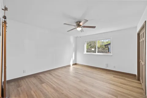 a view of an empty room and wooden floor