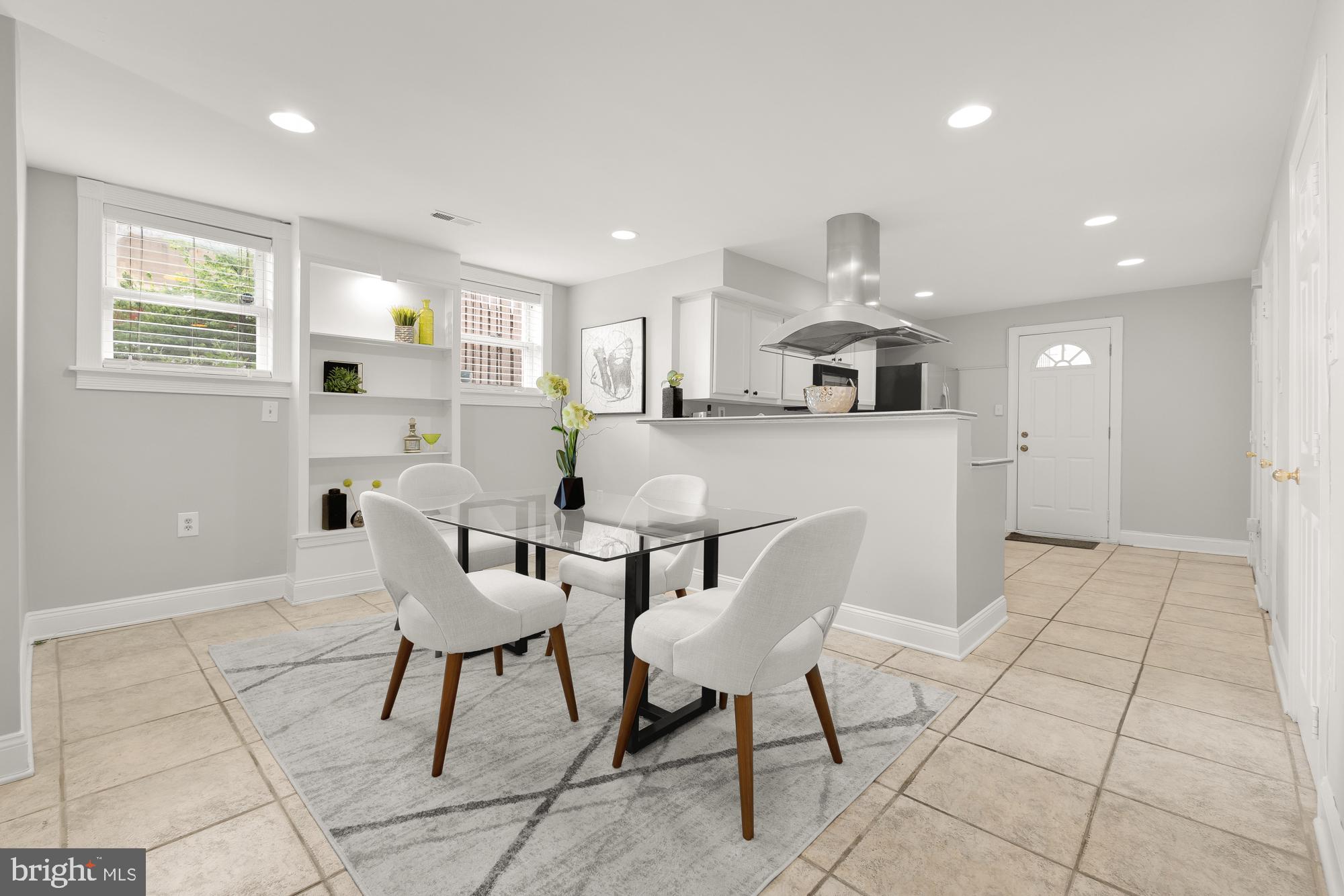 1819 1st Street Northwest, Unit A Washington, DC 20001 - Photo 16 of 38 a kitchen with a dining table chairs and cabinets