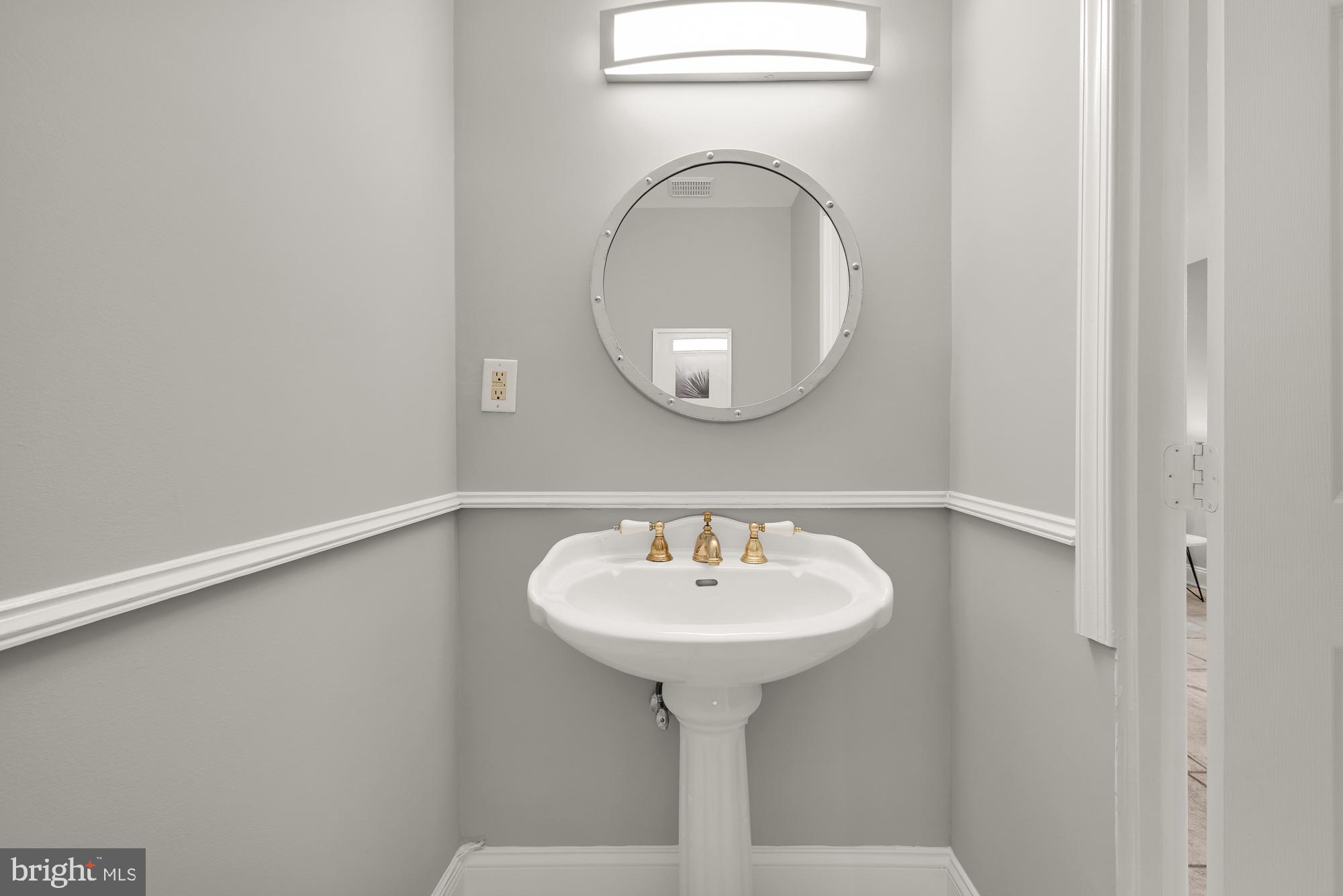 1819 1st Street Northwest, Unit A Washington, DC 20001 - Photo 20 of 38 a bathroom with a sink and a mirror