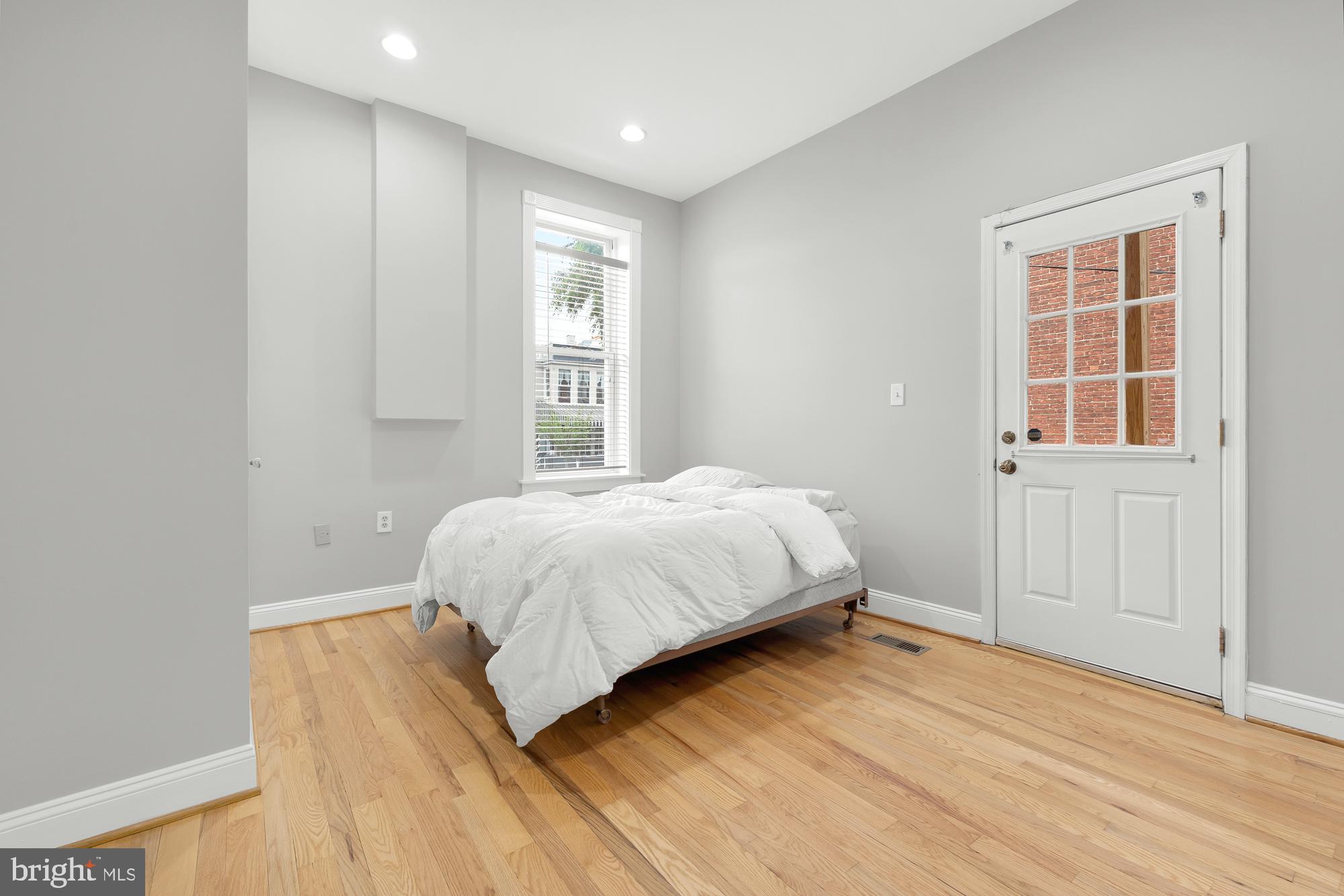 1819 1st Street Northwest, Unit A Washington, DC 20001 - Photo 25 of 38 a bedroom with a bed and a window