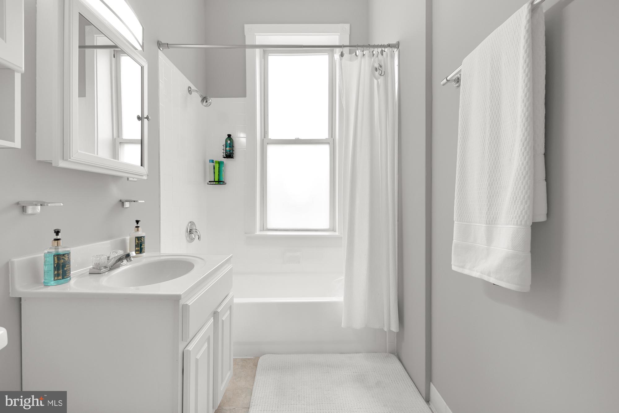 1819 1st Street Northwest, Unit A Washington, DC 20001 - Photo 29 of 38 a bathroom with a sink a mirror and a bathtub
