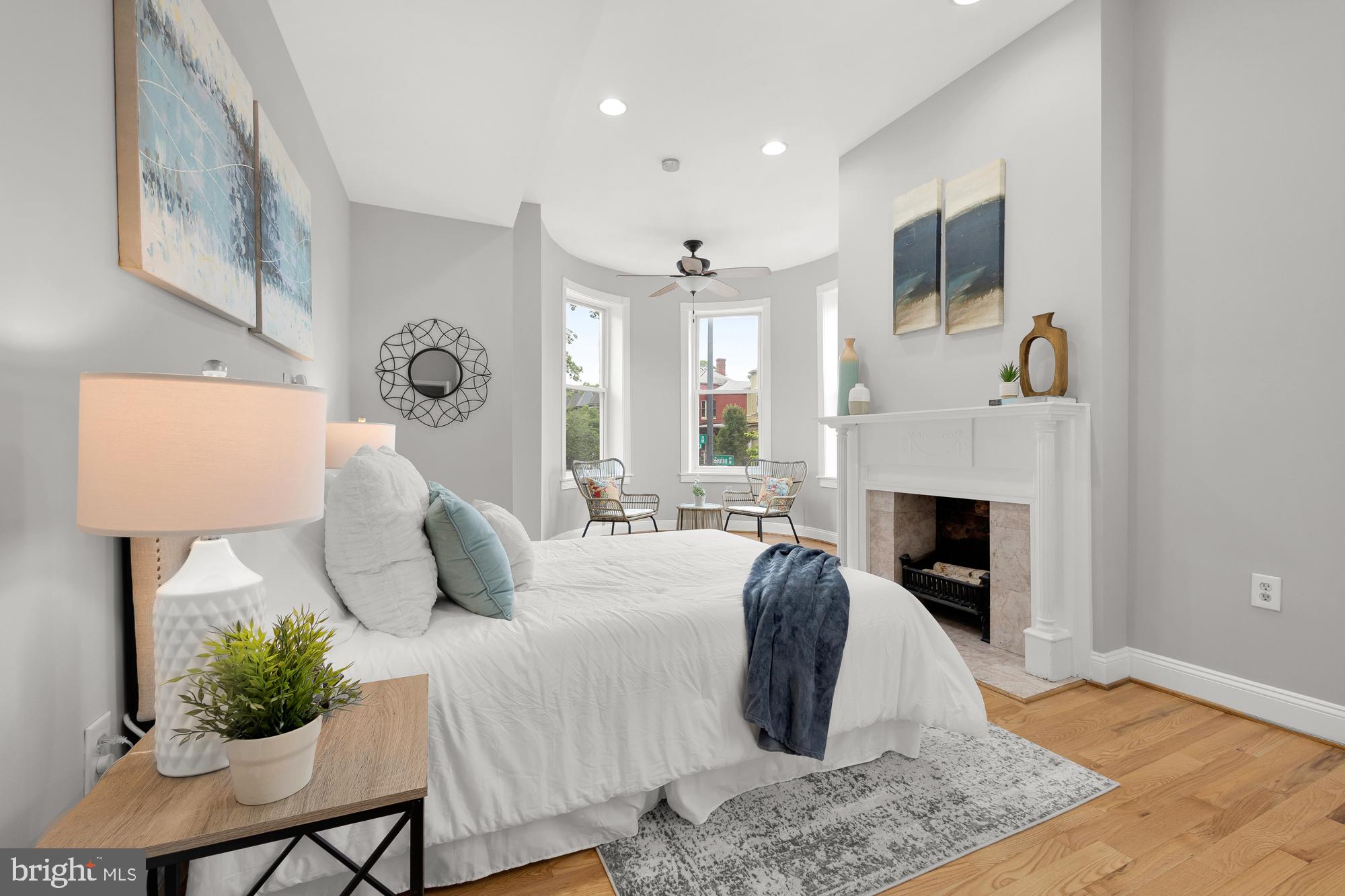 1819 1st Street Northwest, Unit A Washington, DC 20001 - Photo 30 of 38 a bedroom with a bed and a fireplace