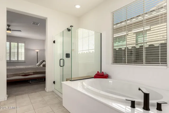 a en suite spacious bathroom with a tub and shower