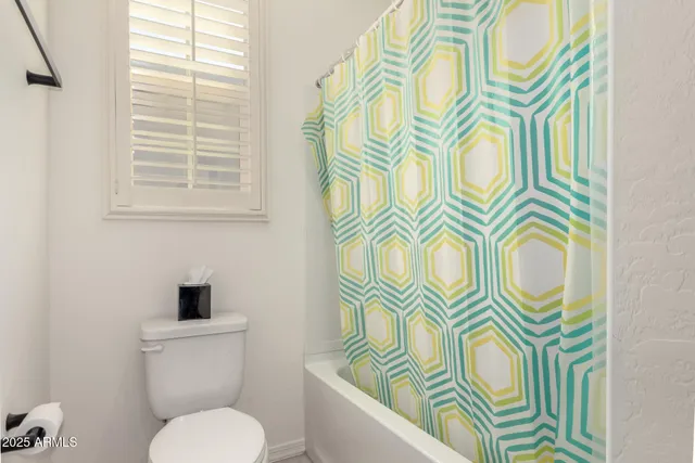 a bathroom with a sink a mirror and a shower curtain