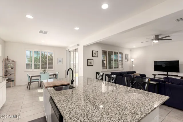 a living room with furniture a rug and a large window