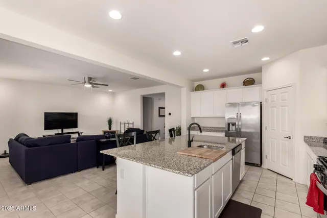 a kitchen with granite countertop a sink appliances and cabinets