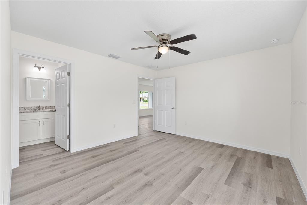 13019 Northeast 7th Loop Silver Springs, FL 34488 - Photo 23 of 35 a view of empty room with wooden floor and window